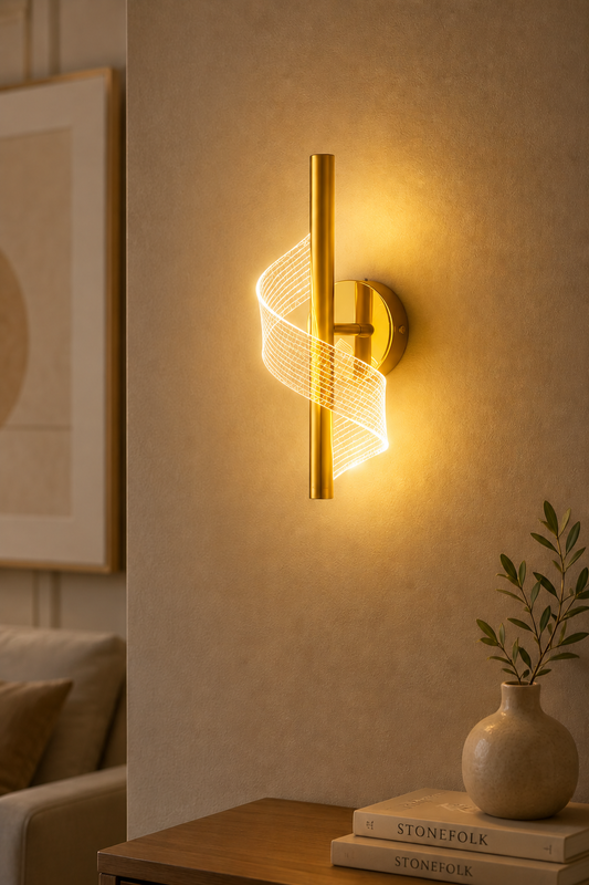 Aurora gold LED wall light with sculptural ribbon design